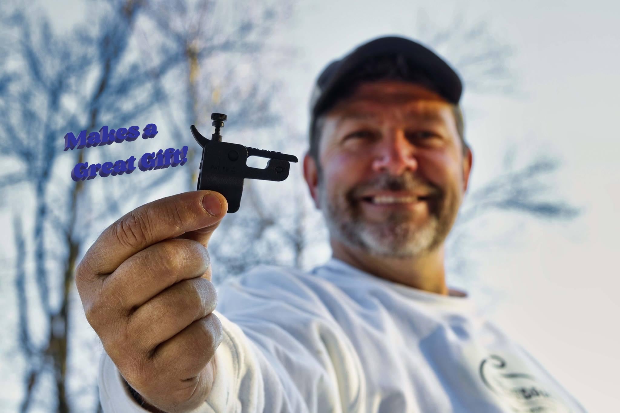 Todd Clayton holding black GhostDrag fishing line release in hand